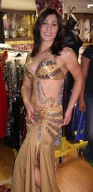 Amelia of the Baltimore Daughters of Rhea Belly Dance Ensemble tries on a Pharaonic style costume