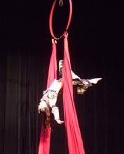 Melina performs a daring combination of Silks, Lyra, and belly dance on air 180