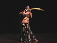 Melina performs a breath taking belly dance while balancing a sword on the tip of a dagger 6