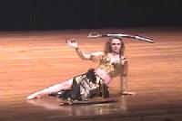 Piper's belly dance floorwork with sword balanced on head