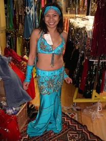 Rowina of the Baltimore Daughters of Rhea Daughters of Rhea Dance Ensemble tries on a two piece turquoise costume