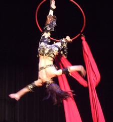 Melina performs a daring combination of Silks, Lyra, and belly dance on air 203