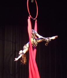 Melina performs a daring combination of Silks, Lyra, and belly dance on air 181