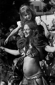 Rhea dancing with Piper on her shoulders and Melinda in her belly at the 1969 Berkeley Fiddler's Convention