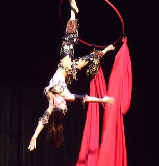 Melina performs a daring combination of Silks, Lyra, and belly dance on air 202