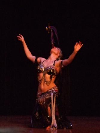 Melina performs a breath taking belly dance while balancing a sword on the tip of a dagger 143