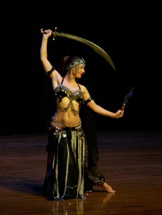 Melina performs a breath taking belly dance while balancing a sword on the tip of a dagger 187