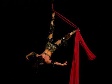 Melina performs a daring combination of Silks, Lyra, and belly dance on air 1203