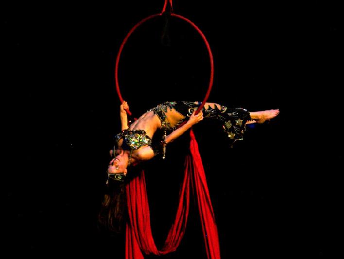 Melina performs a daring combination of Silks, Lyra, and belly dance on air 1207